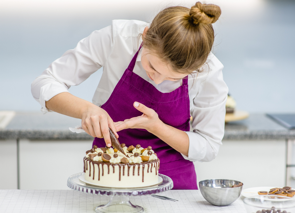 Someone decorating a cake